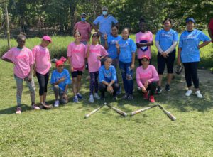 Group of baseball players in greenery with Baseball Bats